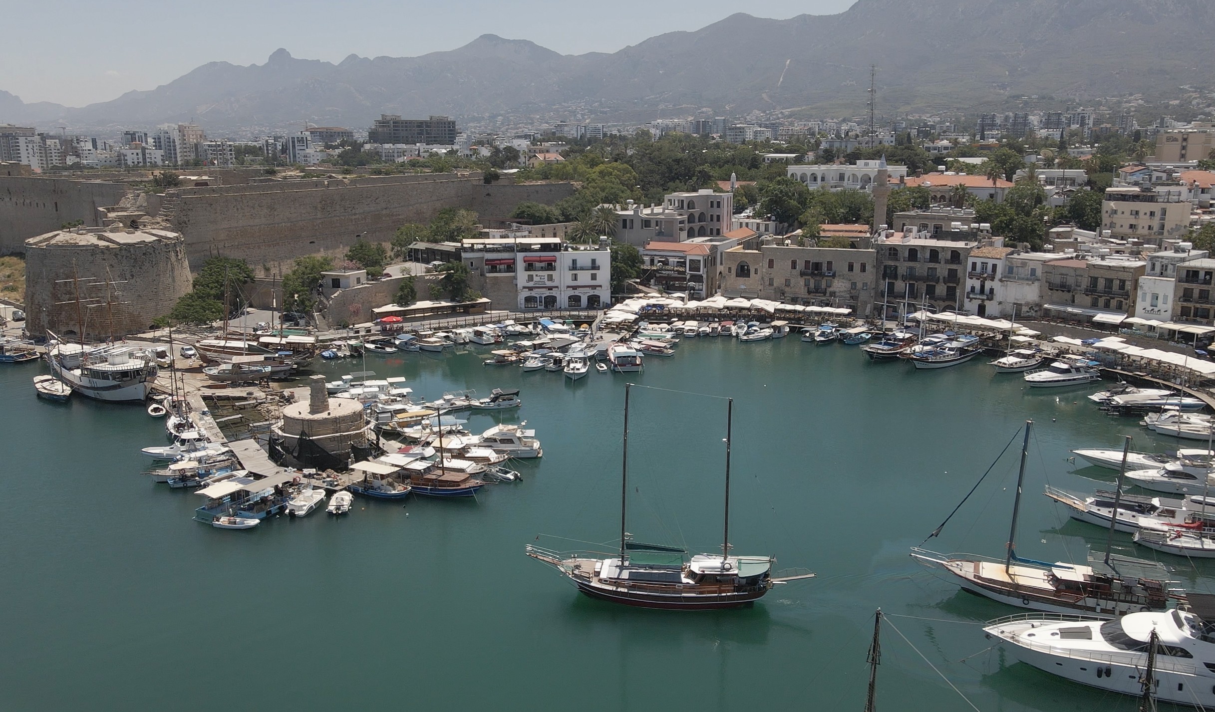 Kyrenia Old Harbour with the city and mountains behind it
